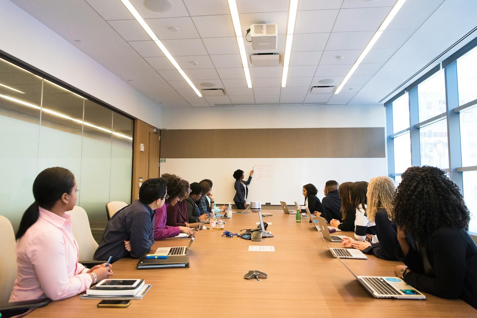 Business meeting with diverse team discussing projects in a modern conference room.